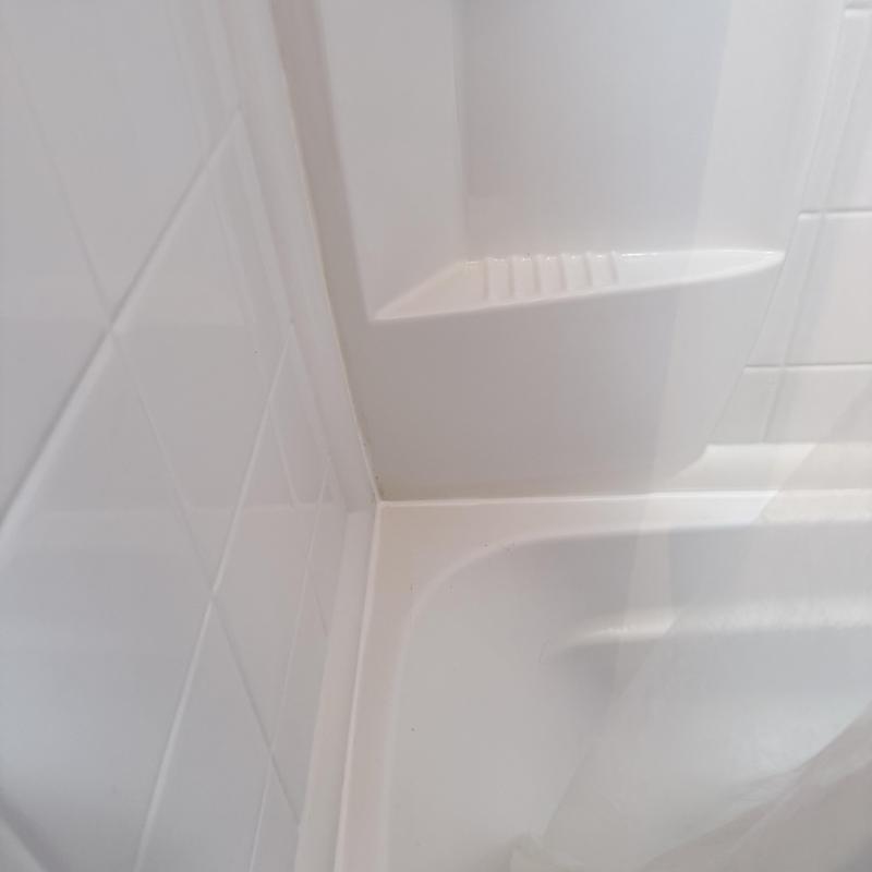 Shower caulk sealed at tub and wall junction