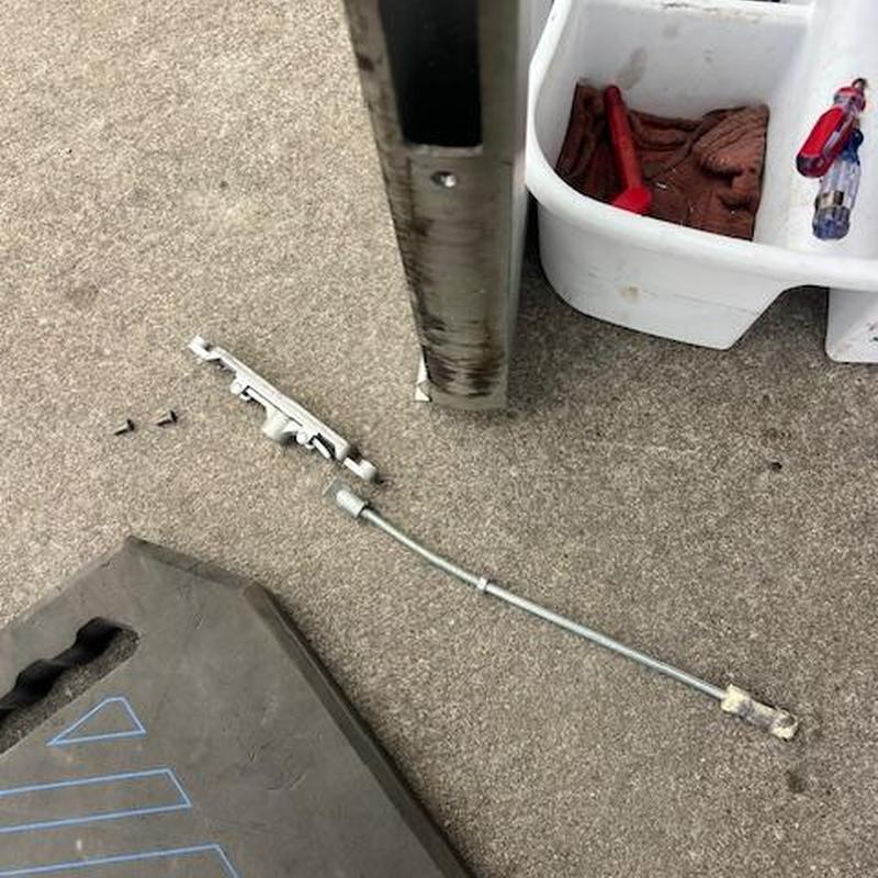 Flushbolt mechanism removed from commercial door bottom