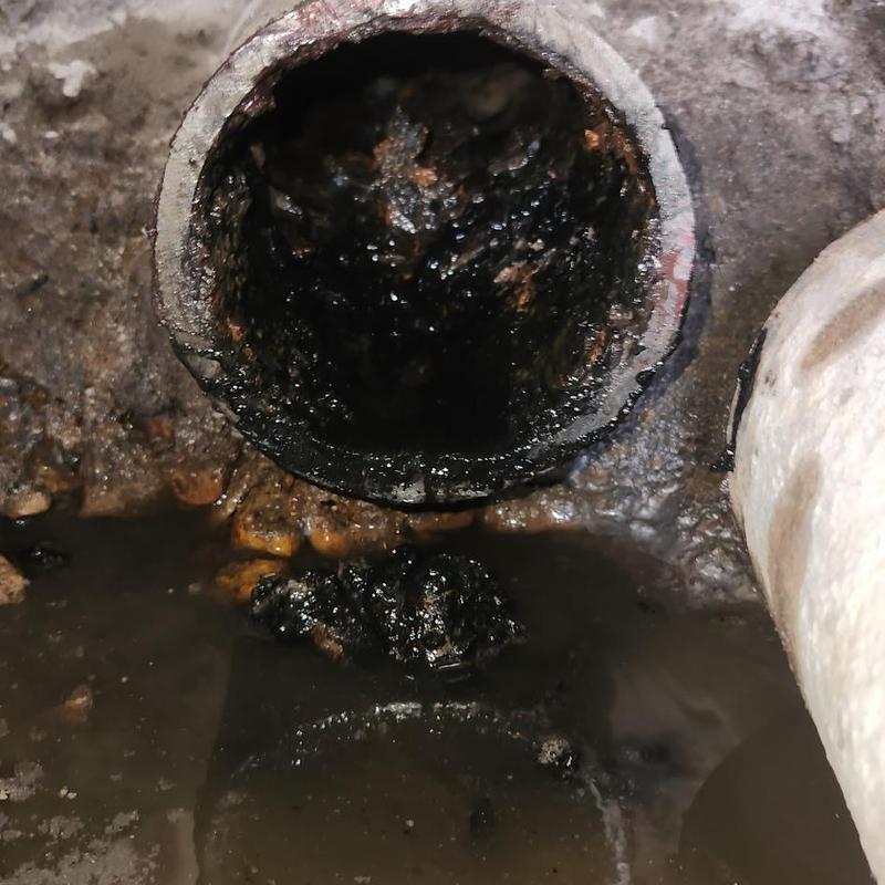 Sewer pipe clogged with sludge and debris