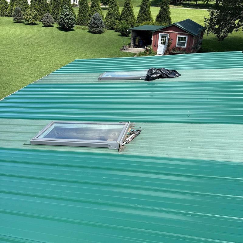 Metal roof with skylight window and vent repair