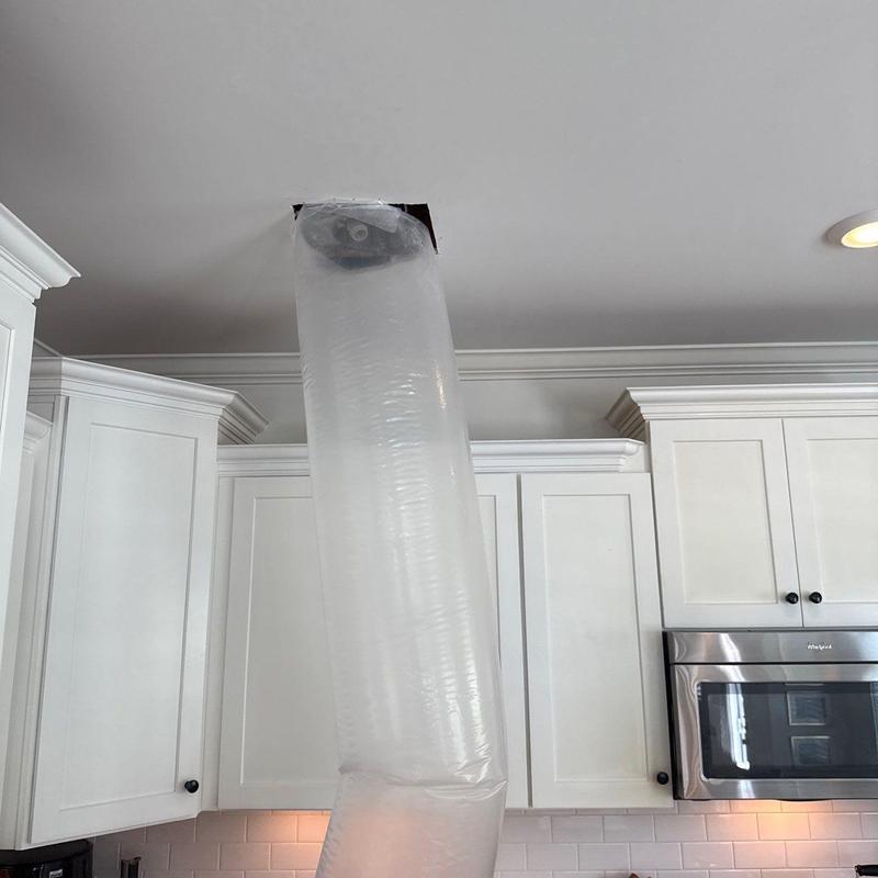 Ceiling vent with air containment bag in kitchen