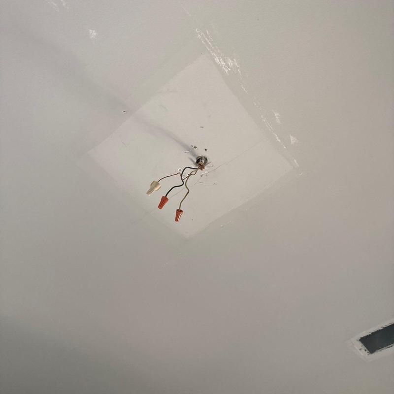 Ceiling electrical box with exposed wiring and wire nuts