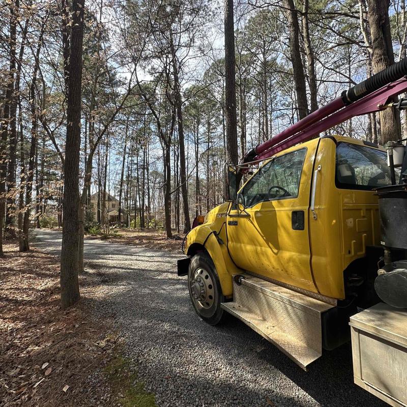 PVC underground plumbing with plumbing truck on gravel road PVC underground plumbing with plumbing truck on gravel road