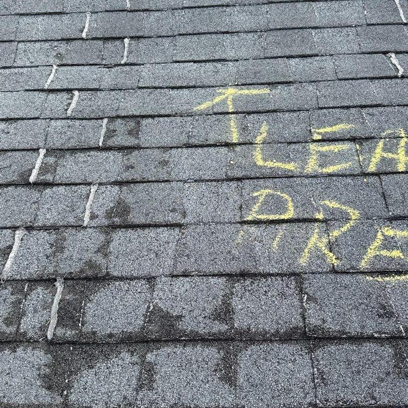 Asphalt shingles with hail damage and chalk markings