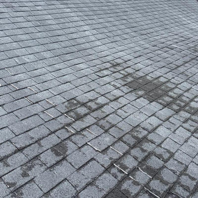 Roof shingles with hail damage and wear marks