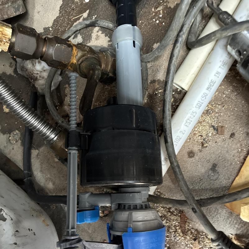 Toilet fill valve assembly with water supply line in bathroom