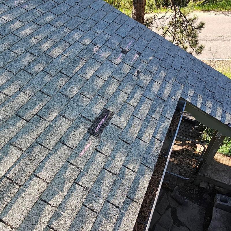 Shingle roof with marked damaged areas and worn granules Shingle roof with marked damaged areas and worn granules