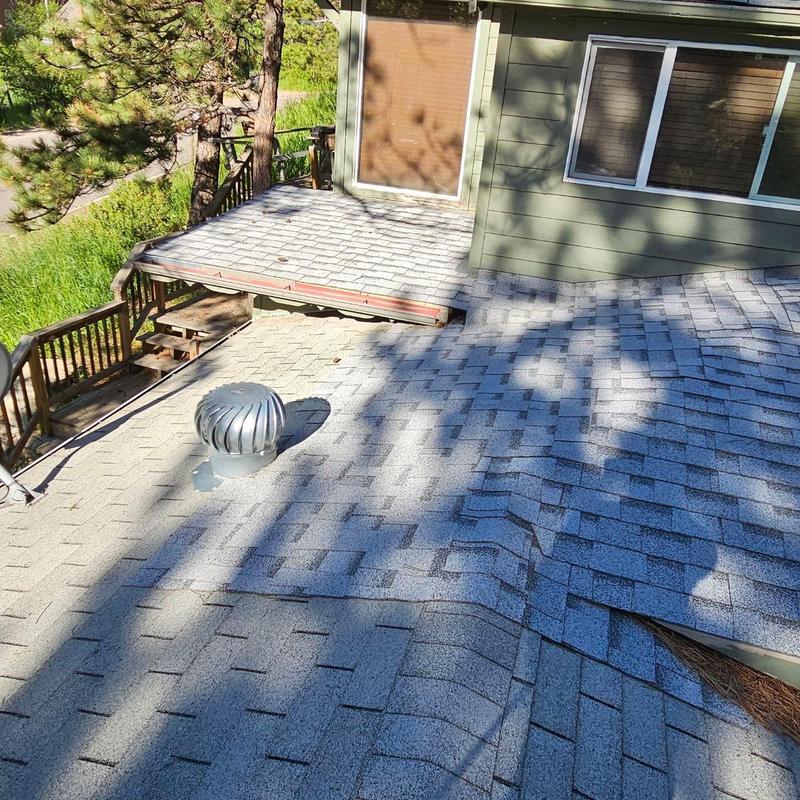 Shingle roof with severe deterioration and granule loss Shingle roof with severe deterioration and granule loss