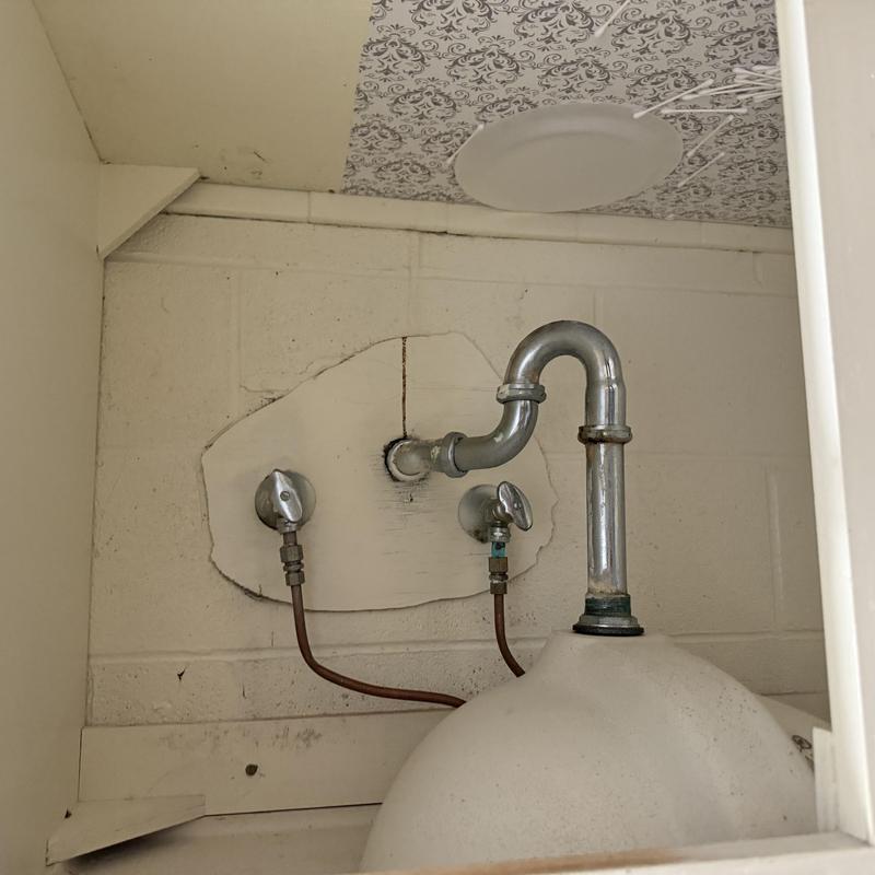 Porch sink drain and water line connections inside cabinet