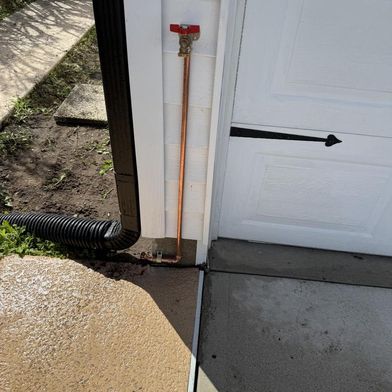 Copper hose bib with new ball valve by garage door