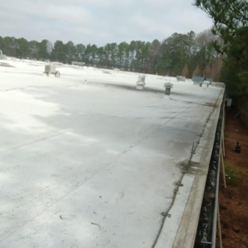 Commercial gutter along flat roof edge in Loganville, GA