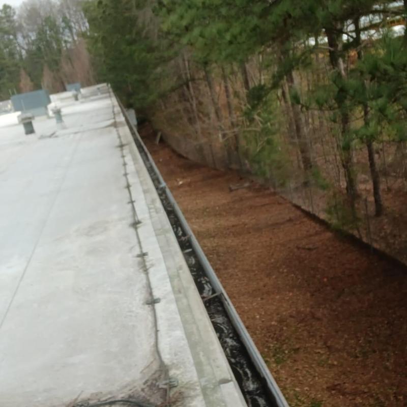 Commercial roof gutter with hand cleaning completed