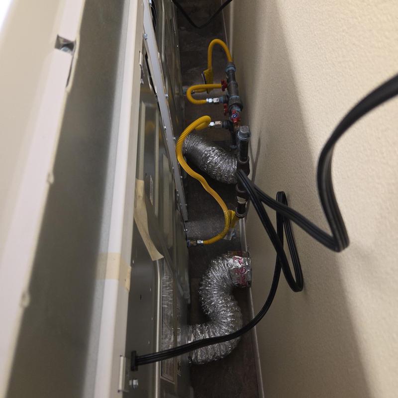 Dryer vent and gas line connections in laundry room