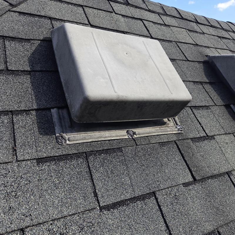 Roof vent flashing with caulk on asphalt shingles