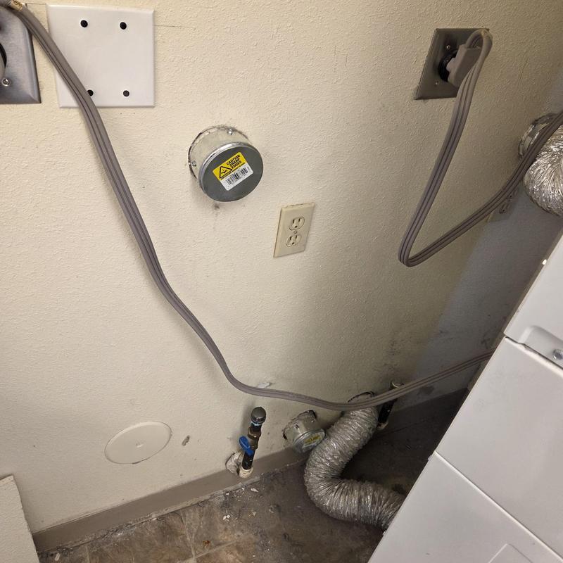 Laundry room gas line capped with vent duct nearby