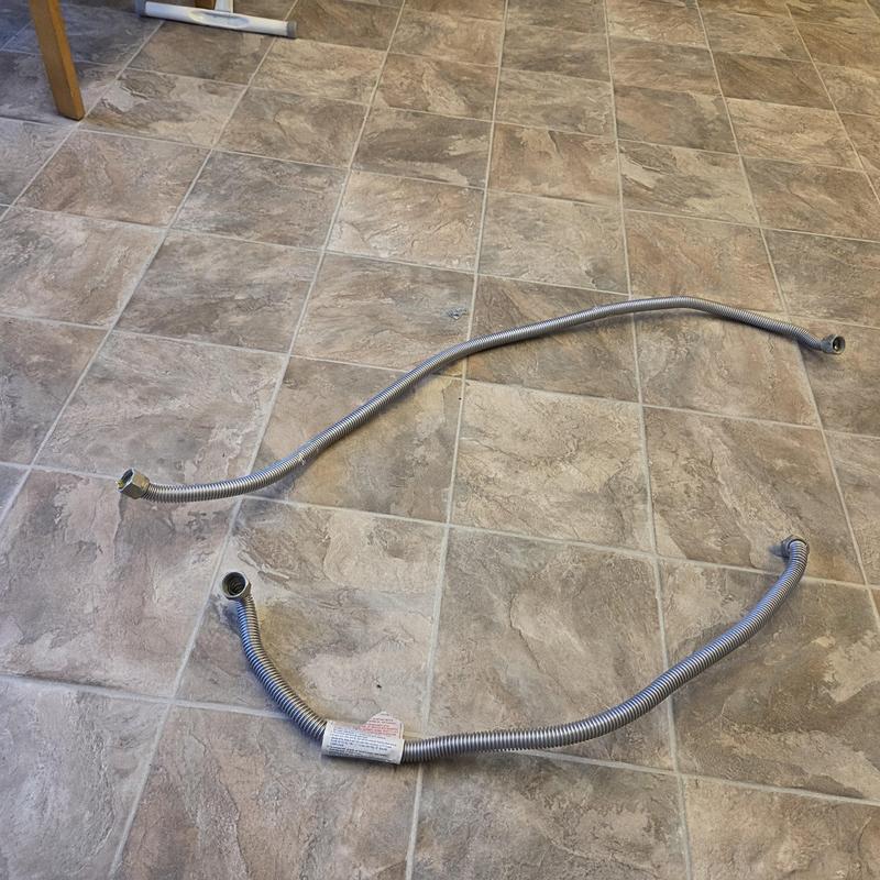 Flexible gas connector lines on tiled floor