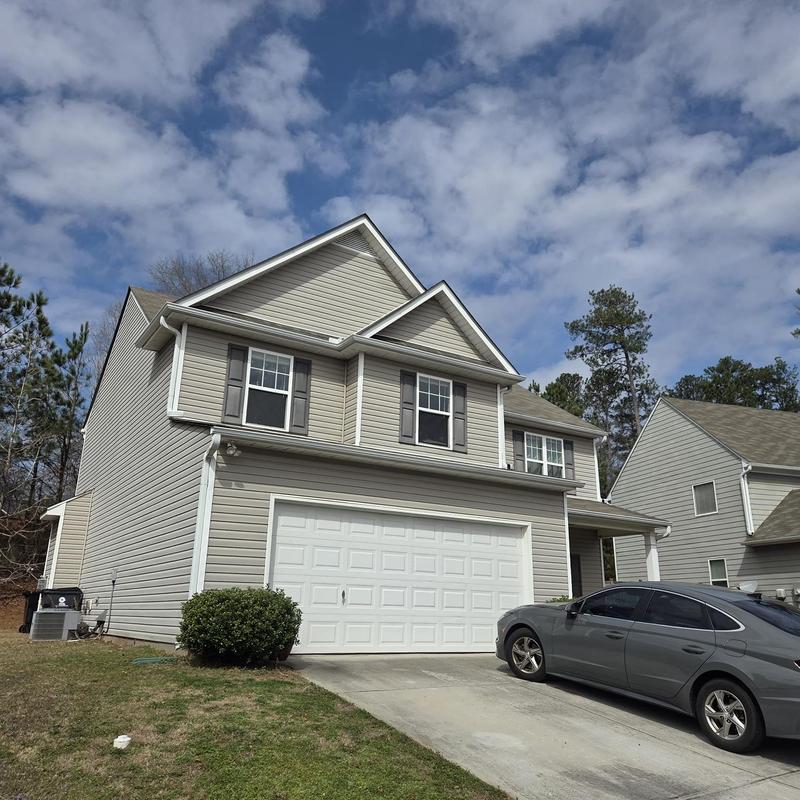 Dryer vent termination with caulked mechanicals on house exterior