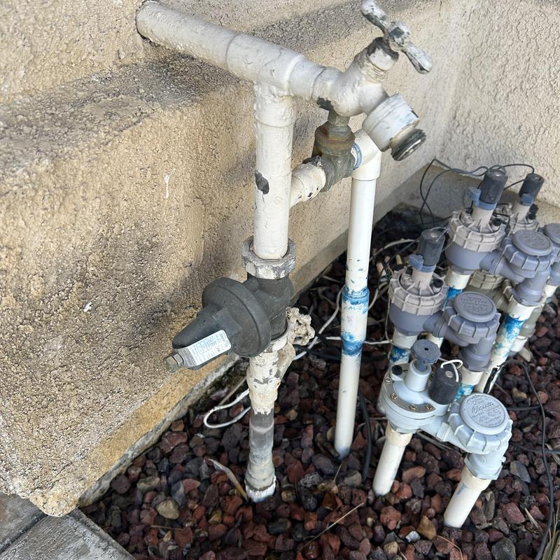 Irrigation valve assembly with control wiring and piping