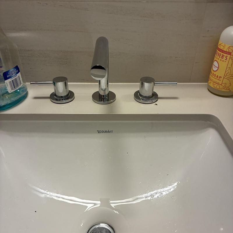 Basin faucet handles with chrome finish adjusted and secured