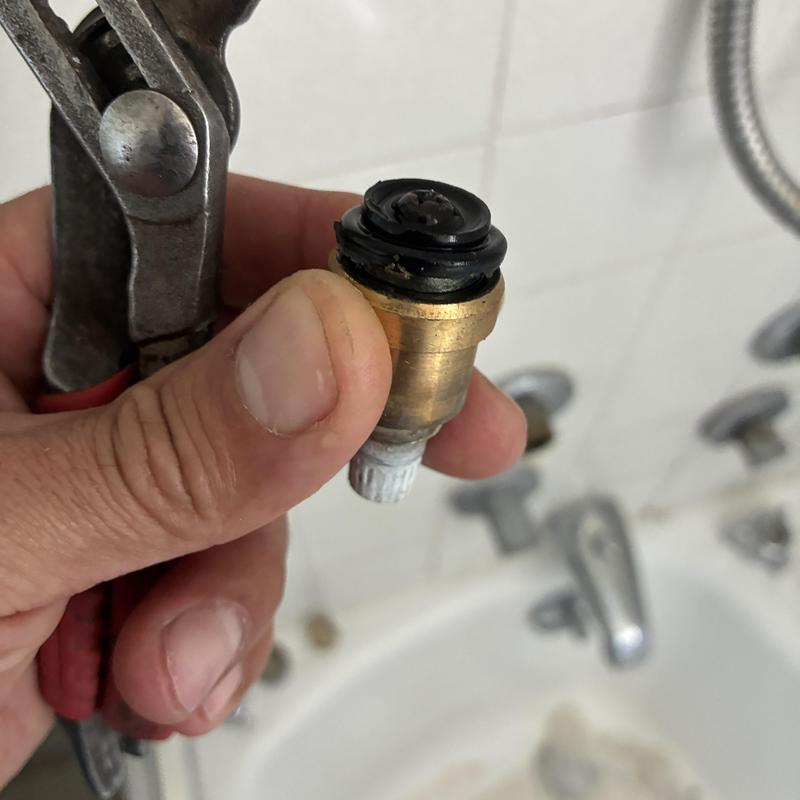 Shower faucet cartridge and washer replacement in progress