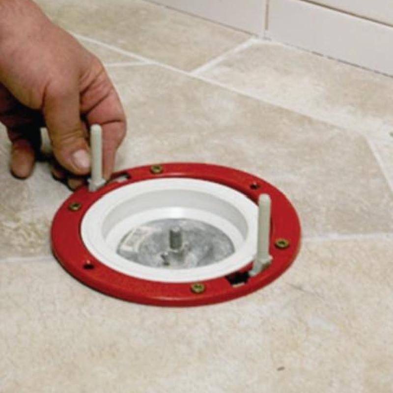 Toilet flange installation on tiled bathroom floor
