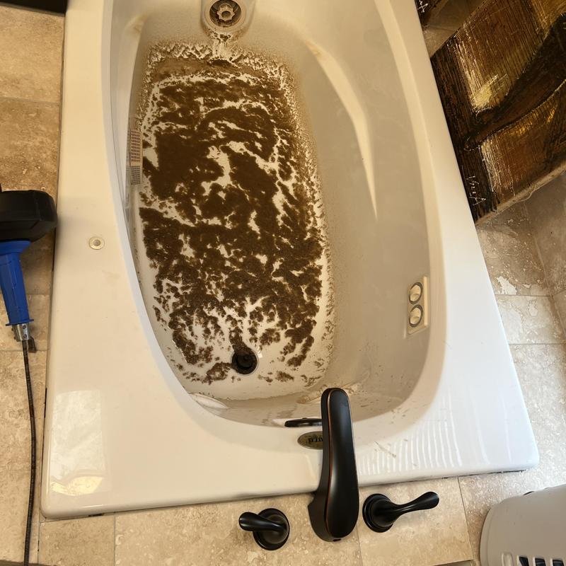 Master bathroom tub with clog residue and drain issue