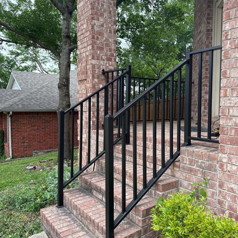 Iron railings on brick stairs with fresh black paint