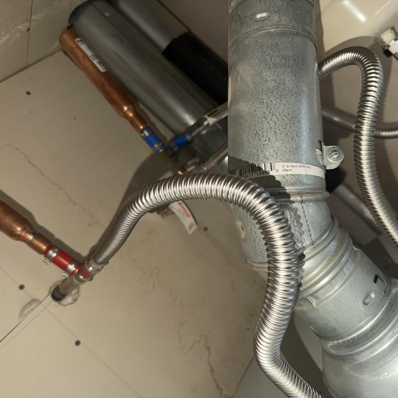 Flexible gas connector and vent pipe on water heater installation