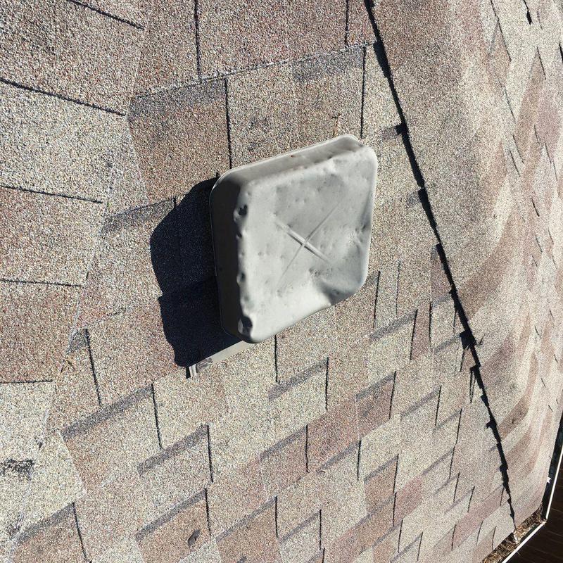 Roof vent cover on shingled roof with hail damage Roof vent cover on shingled roof with hail damage