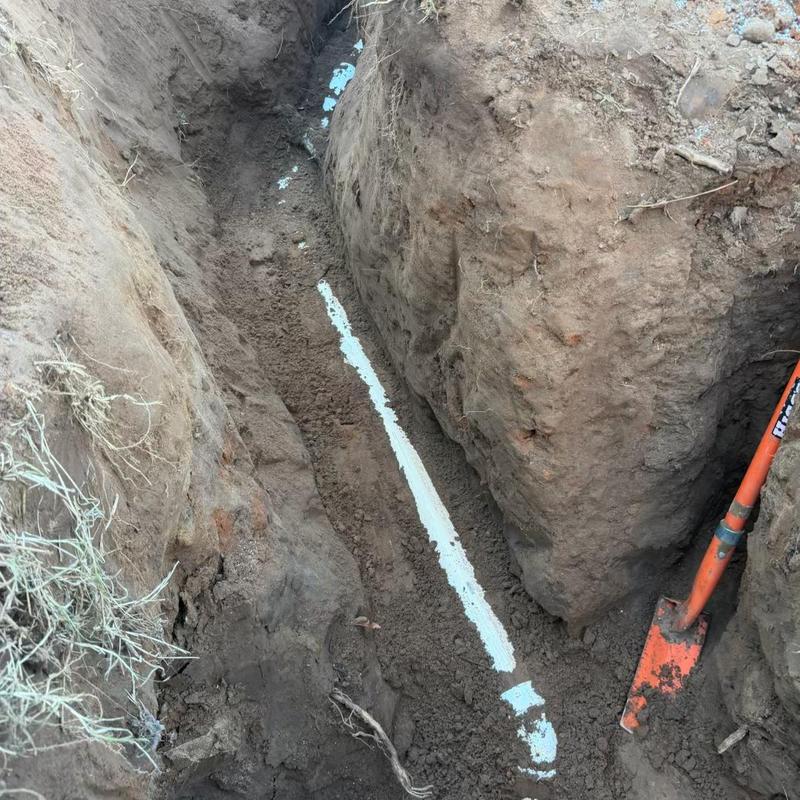 Sewer service line excavation and replacement with pipe