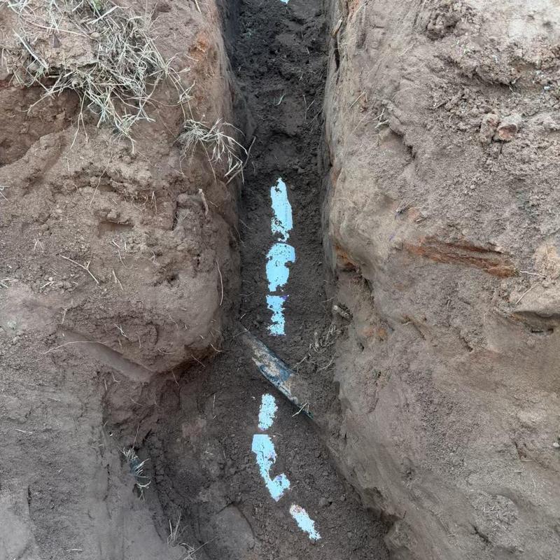 Sewer service line trench excavation with exposed pipe