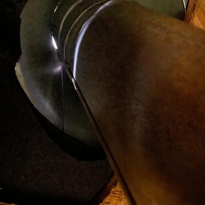 Heater pipe with decking cut for clearance in attic