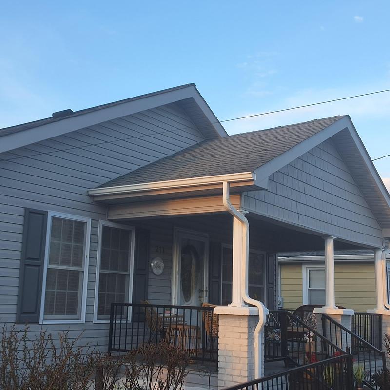 Asphalt shingle roof with porch and gutter system