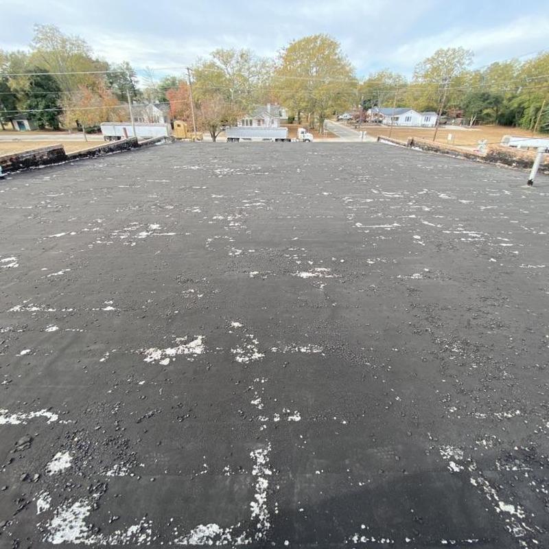 Rolled roofing with metal coping on flat commercial roof