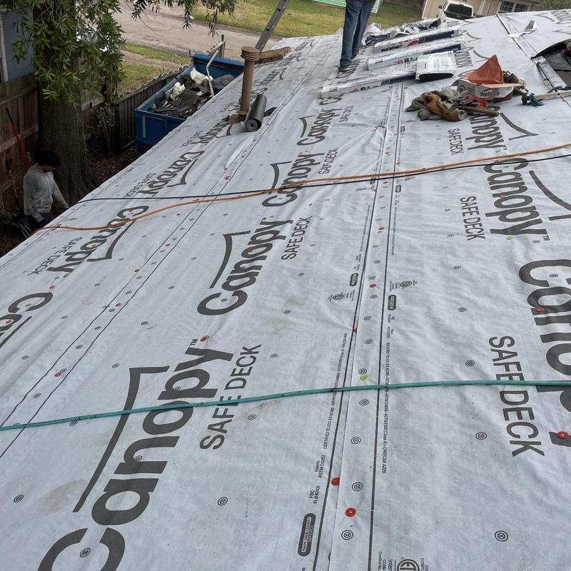 Roof synthetic underlayment installation on residential roof