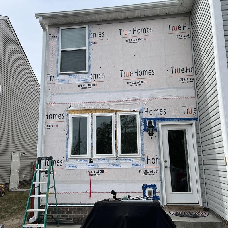 Vinyl window installation on house exterior wall Vinyl window installation on house exterior wall