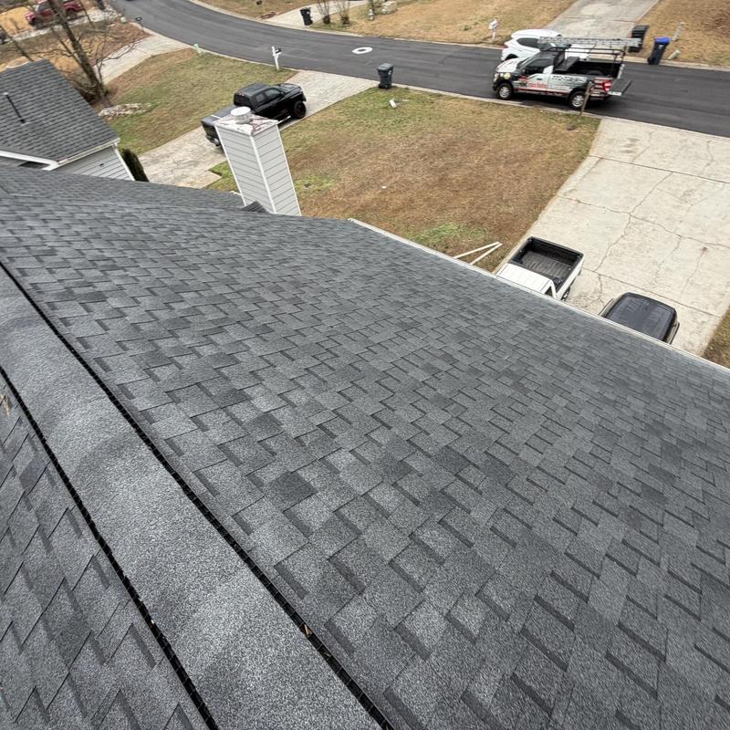 Asphalt shingle roof with sealed ridge cap nails