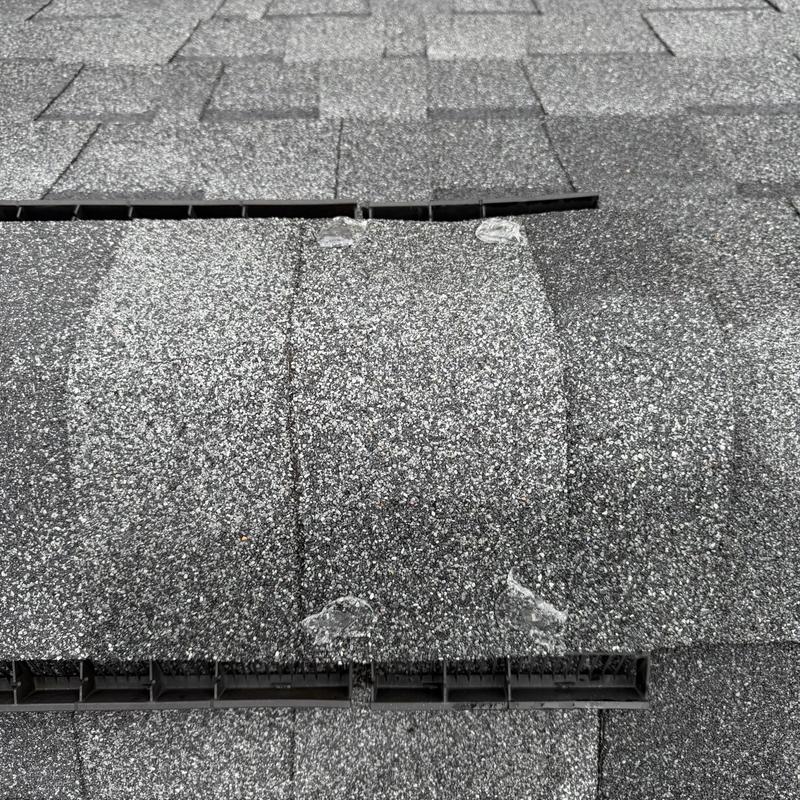 Asphalt shingle ridge with sealed exposed nails and vents