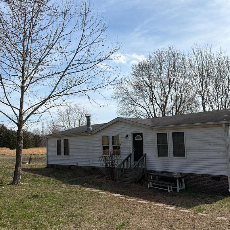 Vinyl siding on mobile home exterior with porch steps