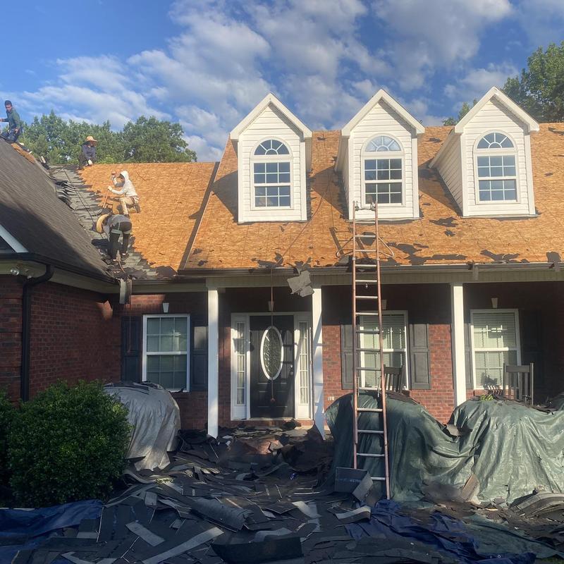 Roof decking replacement with shingle removal in progress Roof decking replacement with shingle removal in progress