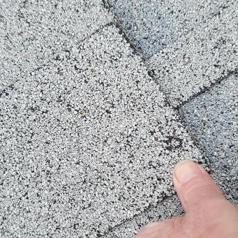 Asphalt shingle roof with hail damage close-up