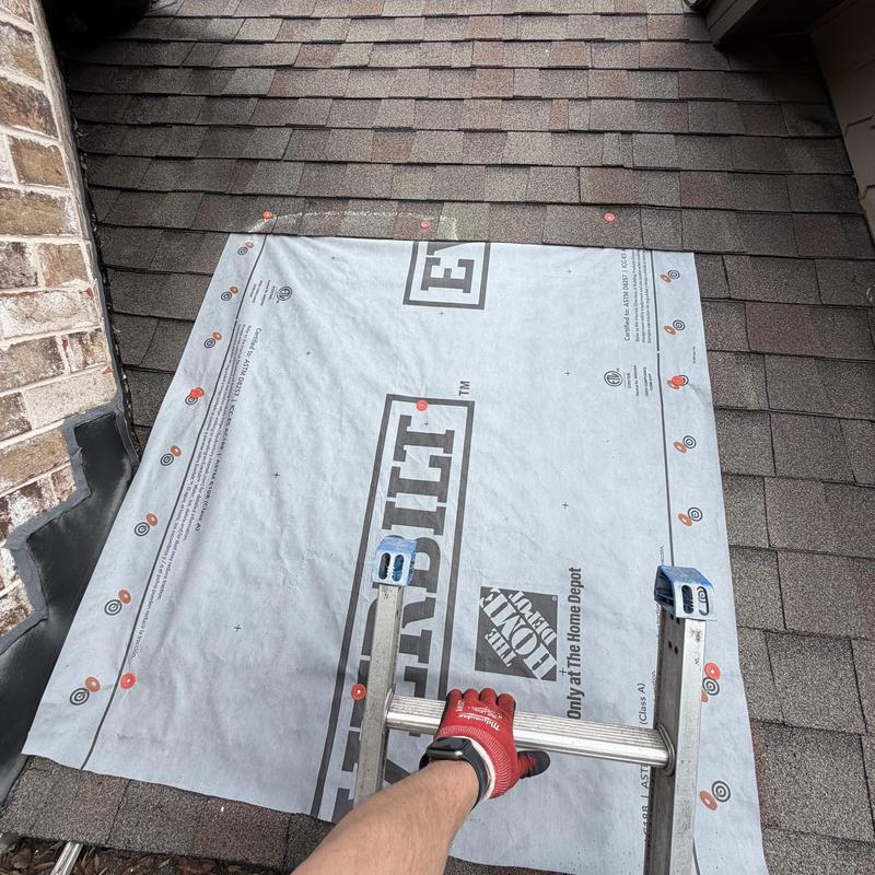 Roof tarp installation over damaged decking near wall flashing