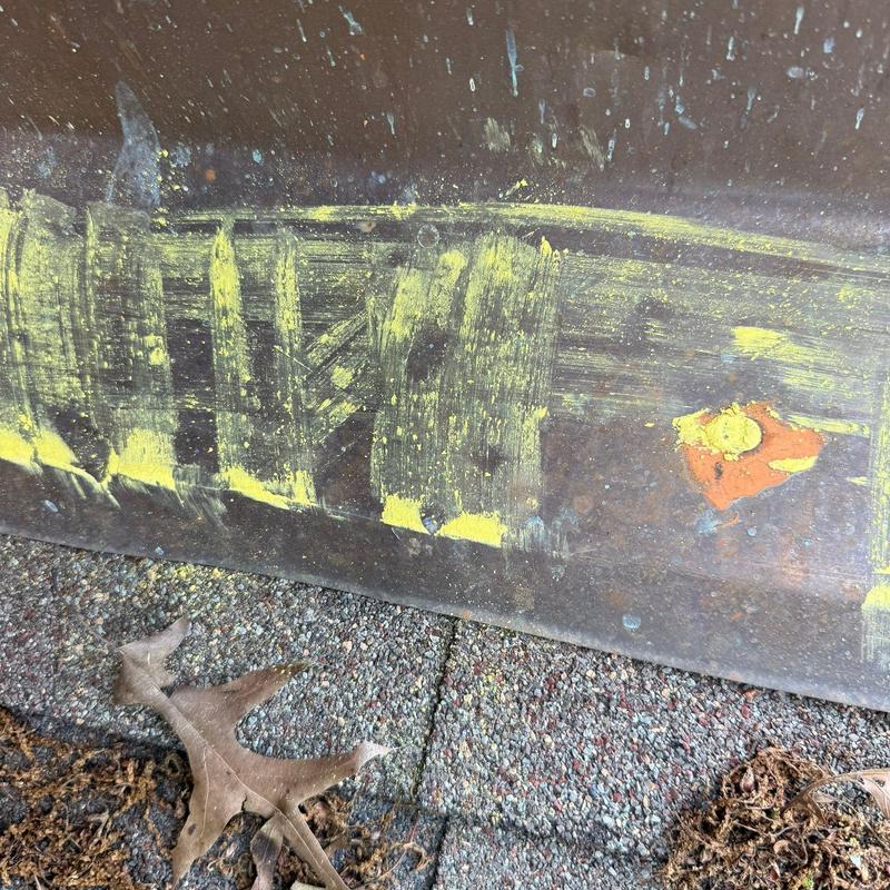 Roof flashing with marked hail damage and wear