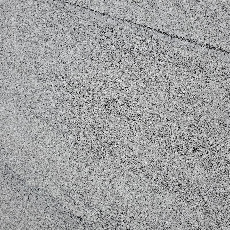 Asphalt roofing granules showing hail and wind damage cracks