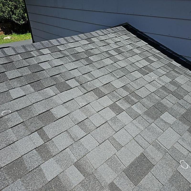 Asphalt shingle roof with marked hail damage spots Asphalt shingle roof with marked hail damage spots