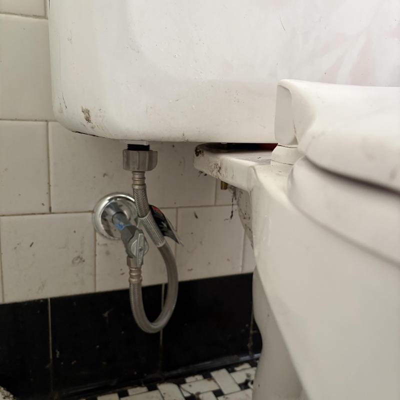 Toilet tank with new emergency shut-off valve installed