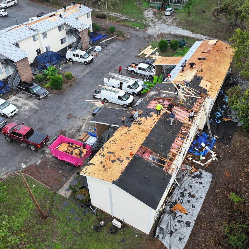 Asphalt shingle roof removal and replacement in progress Asphalt shingle roof removal and replacement in progress