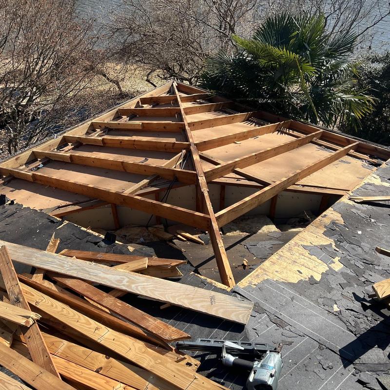 Roof framing and plywood deck during removal in Greenwood Roof framing and plywood deck during removal in Greenwood