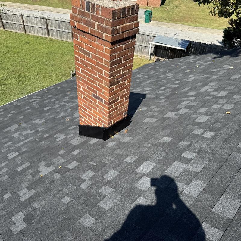 Onyx Black Owens Corning shingles around brick chimney