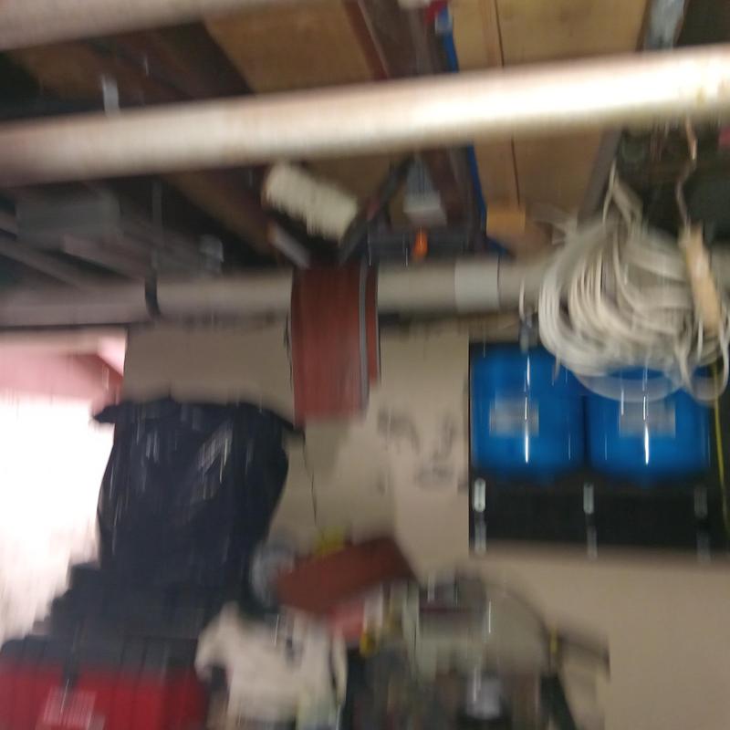 Main line plumbing pipes and water tanks in basement Main line plumbing pipes and water tanks in basement